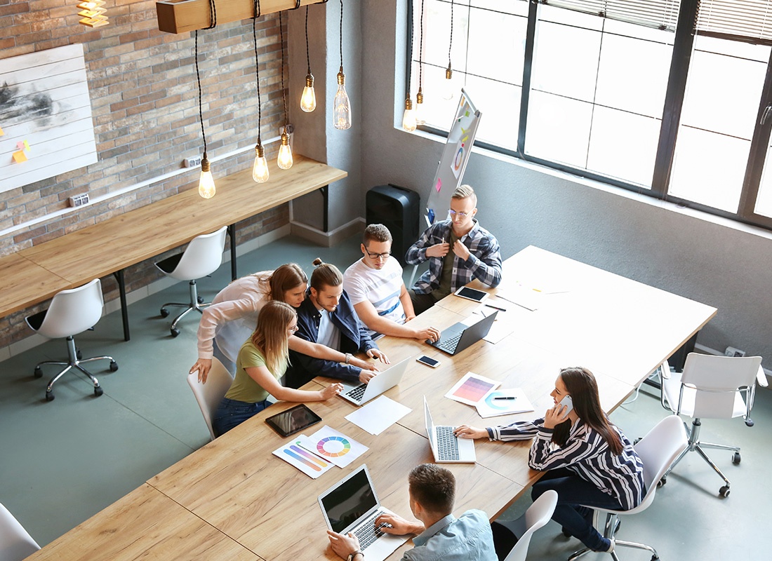 East Bethel, MN - Young People Having Business Meeting in Modern Office