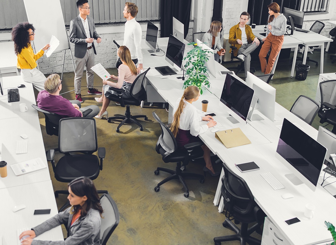 Mankato, MN - High Angle View of Professional Young Business People Working Together in Open Space Office